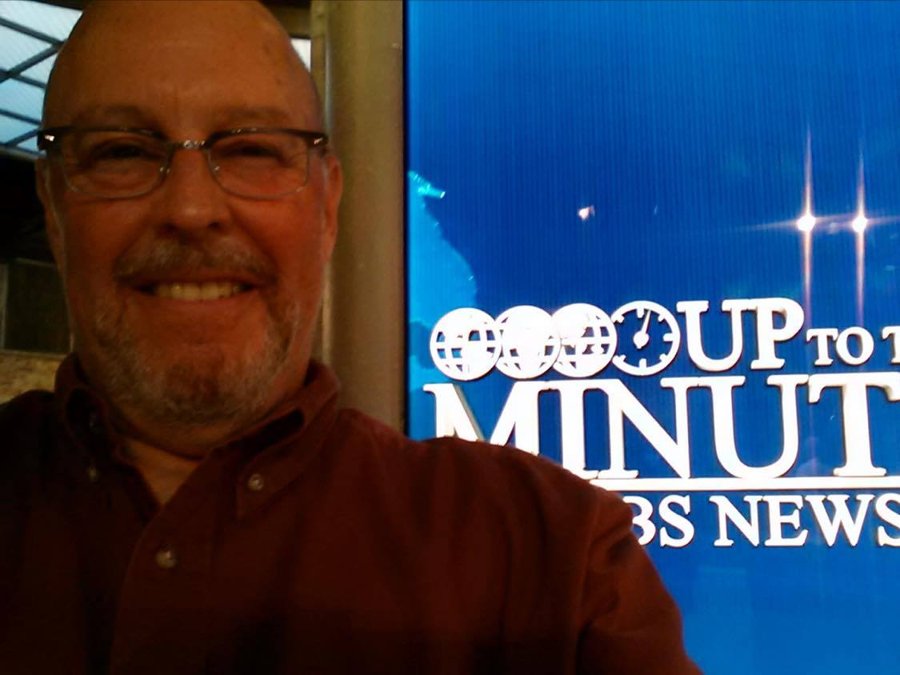 Norman Gittleson beside the CBS News Up To The Minute sign